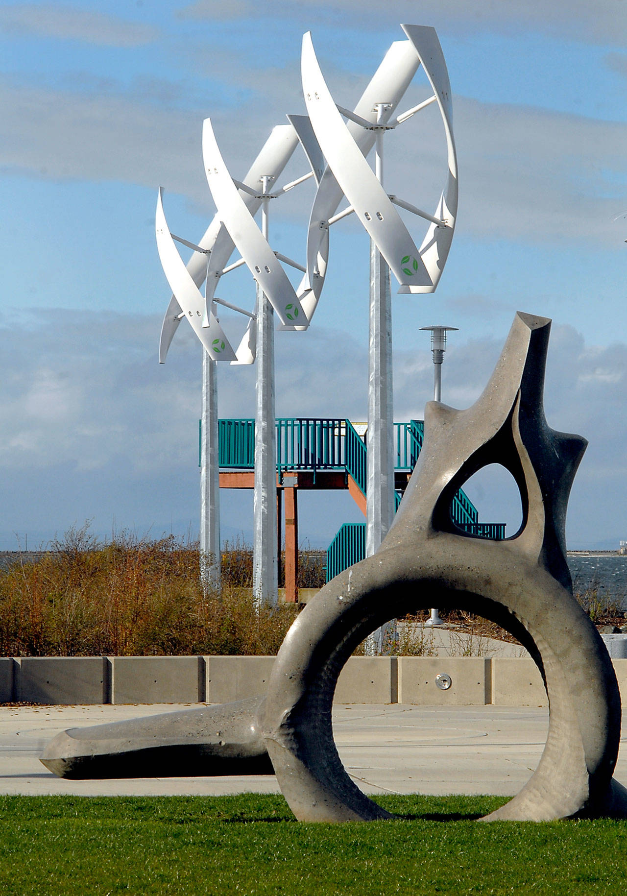 Three “wind spires” spin in the breeze next to the whalebone sculpture in West End Park along the Port Angeles waterfront Wednesday. (Keith Thorpe/Peninsula Daily News)
