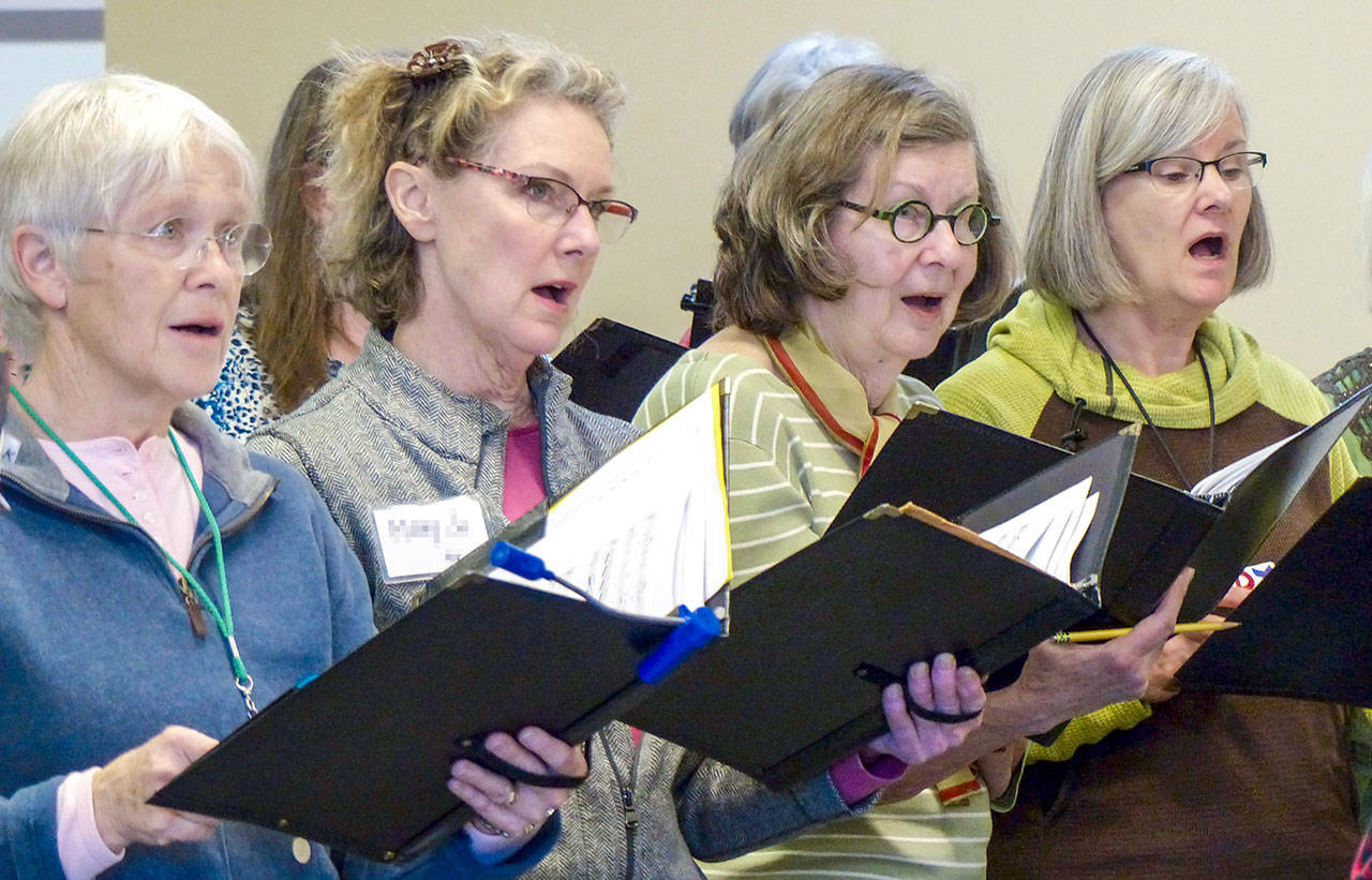 Altos in the Community Chorus of Port Townsend and East Jefferson County are, from left, Pat McMinds, Mary Jo Mackenzie, Cass Dahlstrom and Jody Glaubman, shown here rehearsing for the Community Chorus concerts slated tonight and Sunday, which will salute the national parks. (Sue Reid)