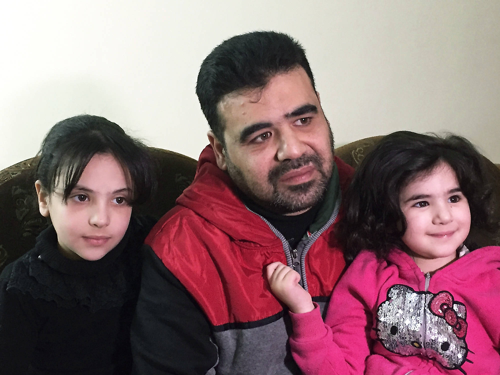 Karin Laub/The Associated Press                                Syrian refugee Mahmoud Mansour, 43, is shown in this photo, taken March 6 in Amman, with his daughters Ruba, 9, and Sahar, 3. Mansour, who has been undergoing vetting for resettlement to the U.S. for the past year, says he was devastated by President Donald Trump’s travel ban and remains confused about how the revised version could affect his hopes for future in the U.S.