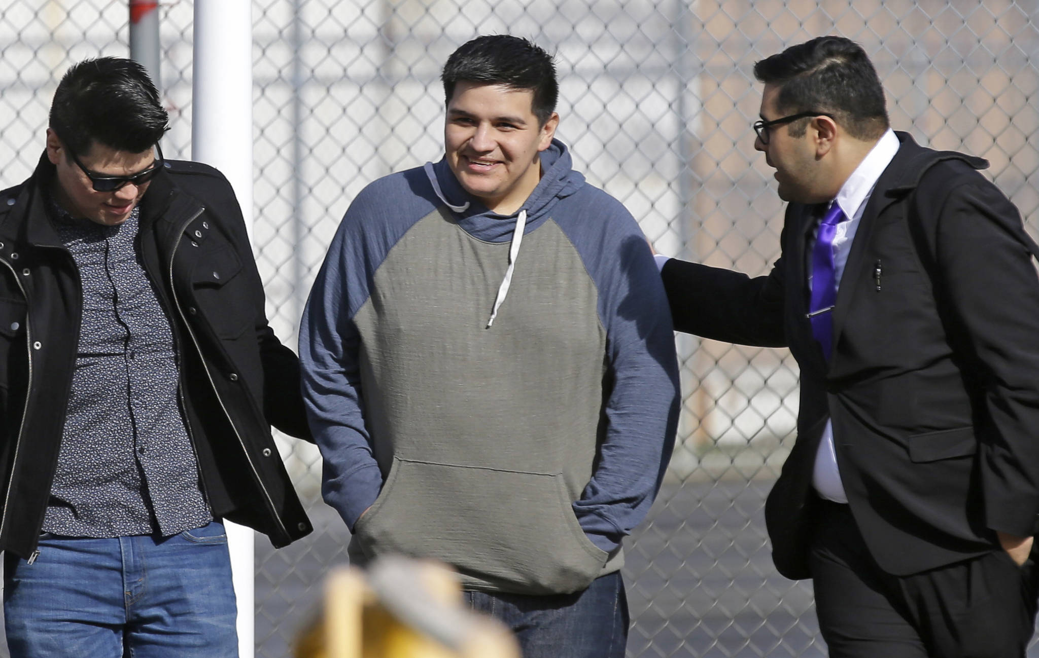 Daniel Ramirez Medina, center, walks out of the Northwest Detention Center in Tacoma with his attorney, Luis Cortes, right, and his brother, who has not been identified by name, after Ramirez was released from federal custody Wednesday. (Ted S. Warren/The Associated Press)