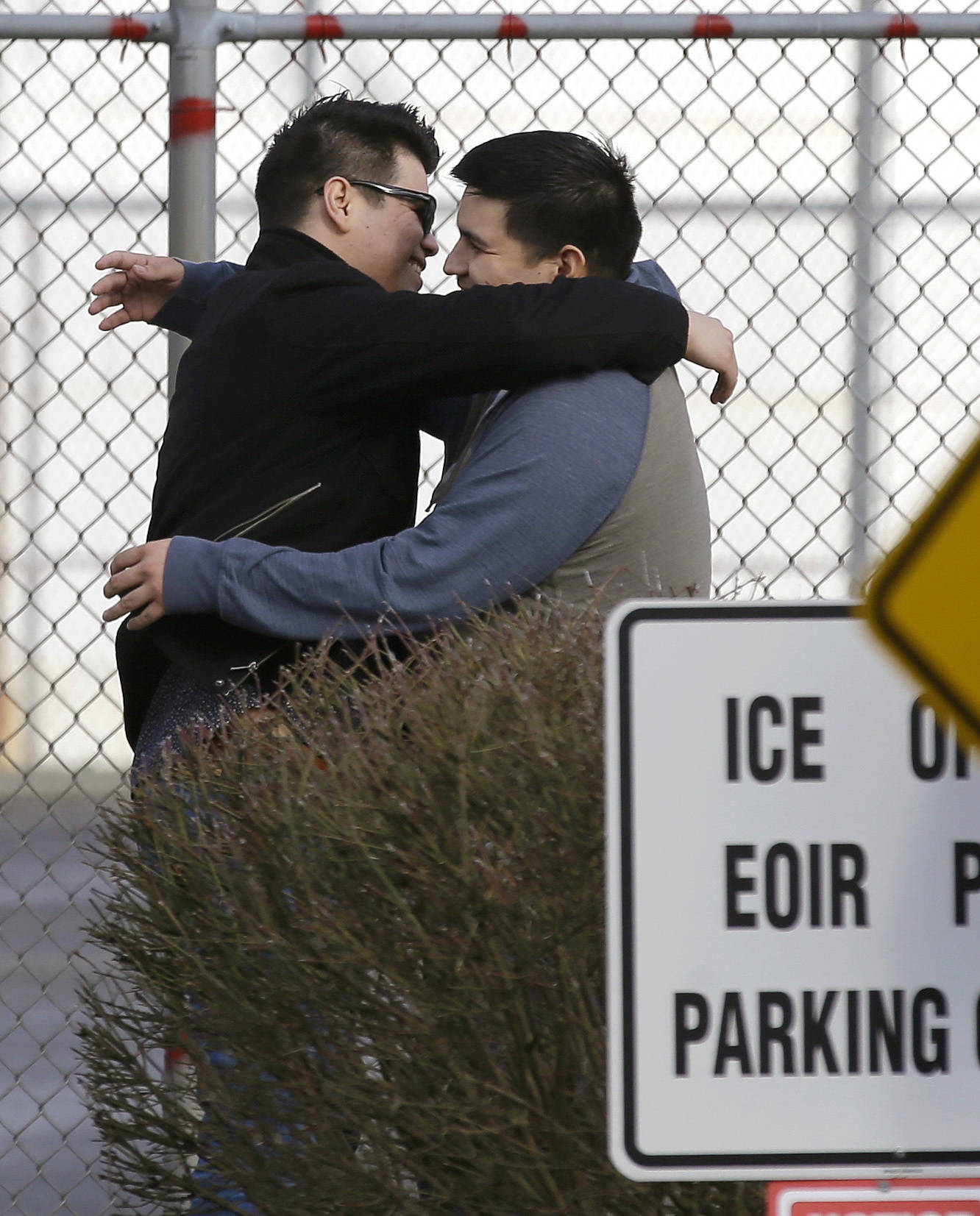 Daniel Ramirez Medina, right, hugs his brother, left, who has not been identified by name, after Ramirez walked out of the Northwest Detention Center in Tacoma after Ramirez was released from federal custody Wednesday. (Ted S. Warren/The Associated Press)