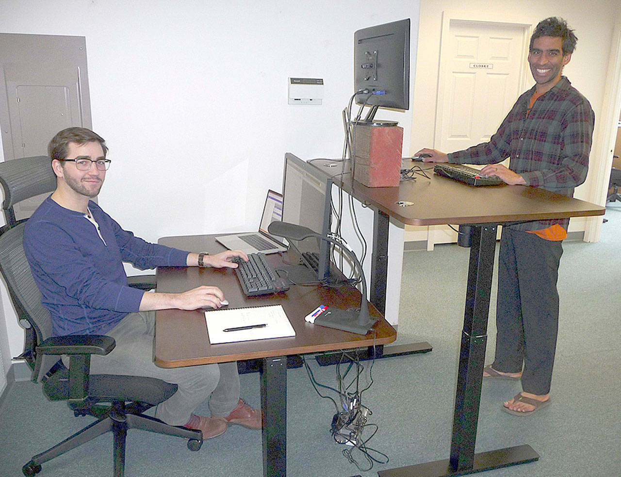 Patricia Morrison Coate/Olympic Peninsula News Group                                Edward Unthank, left, and Ankur Shah, right, display two different work station configurations at Clallam Coworking in Sequim.