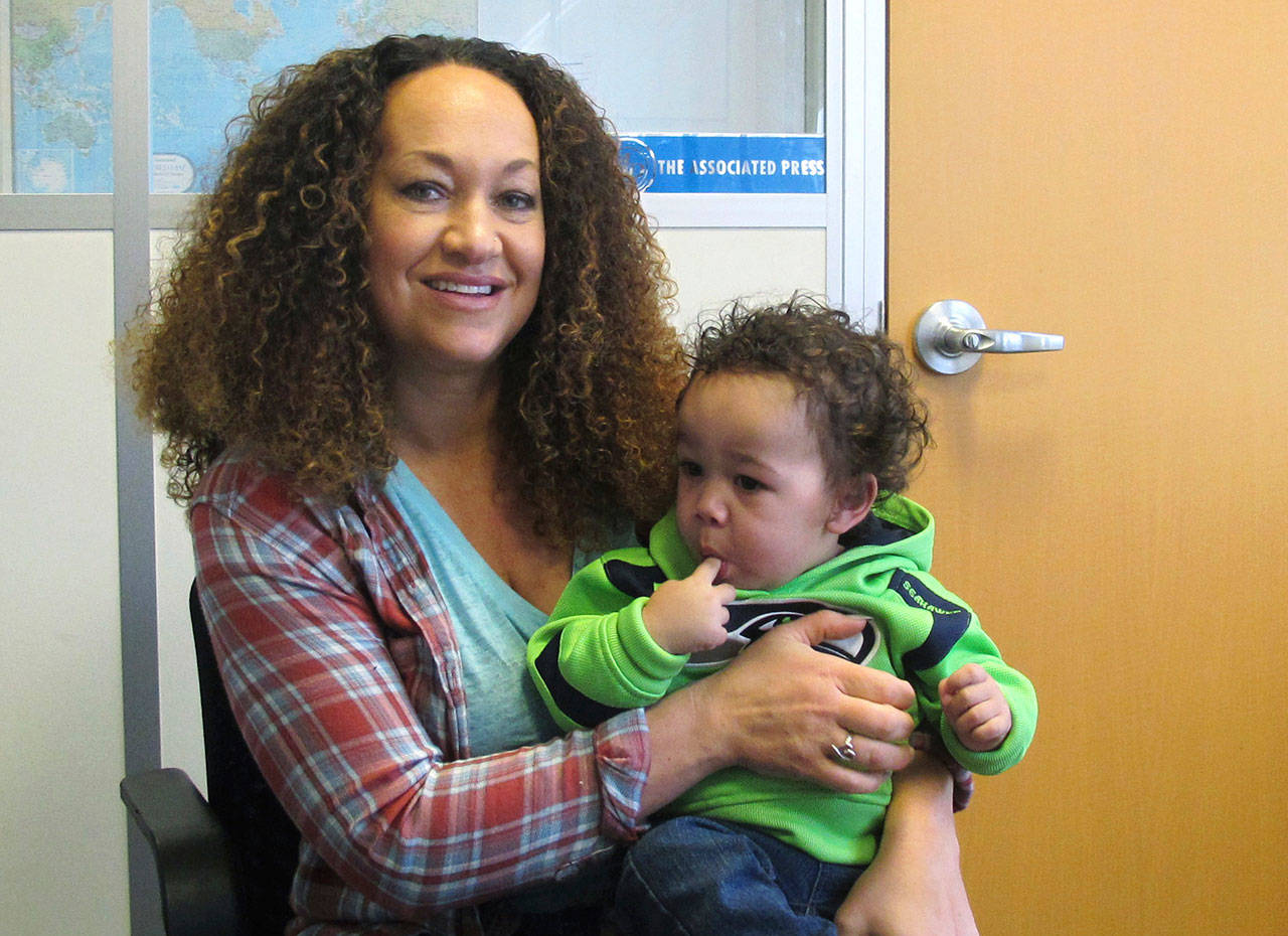 Rachel Dolezal poses for a photo with her son, Langston, in the bureau of the Associated Press in Spokane.(Nicholas K. Geranios/The Associated Press)