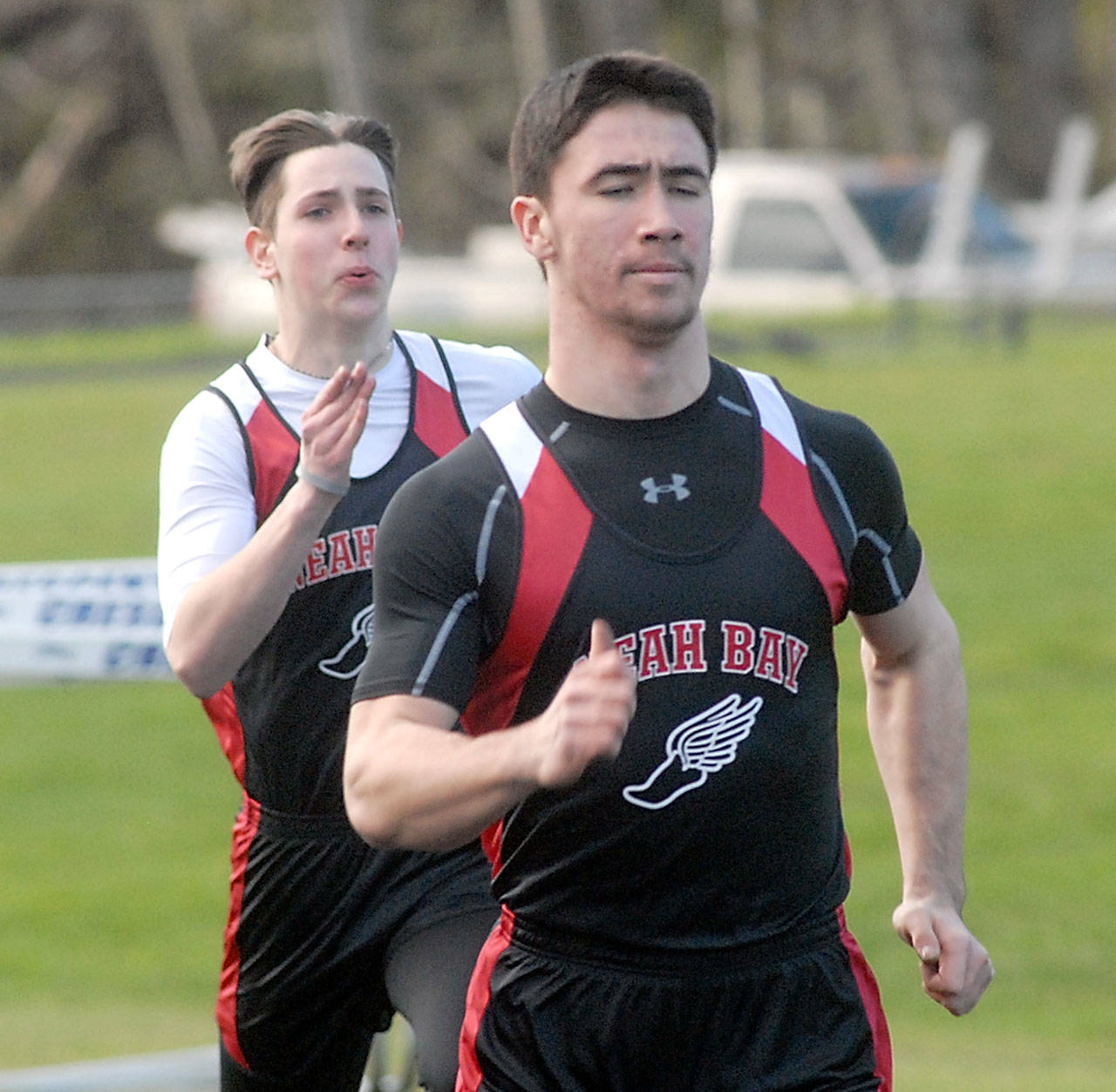 Keith Thorpe/Peninsula Daily News Neah Bay&rsquo;s Cameron Buzzell races to win his heat in the 100 meter dash as teammate Chris Tageant follows behind on Thursday in Joyce.