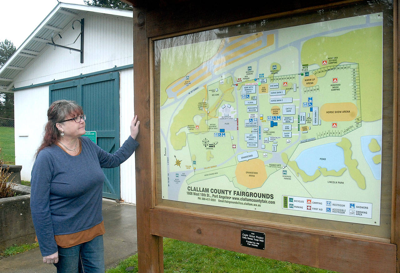 Clallam County Fair manager Shari Ioffrida looks over a map of the fairgrounds in Port Angeles on Wednesday. (Keith Thorpe/Peninsula Daily News)