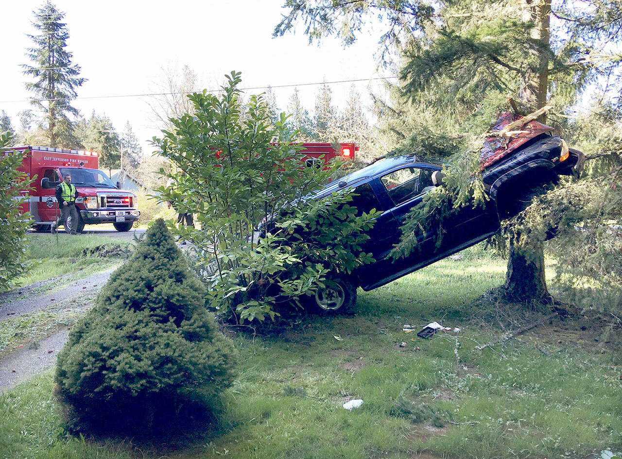 Two women were flown to Harborview Medical Center after this vehicle drifted off the pavement, hit a driveway berm and became airborne before striking a tree on Four Corners Road near Port Townsend on Thursday. (Bill Beezley/East Jefferson Fire-Rescue)