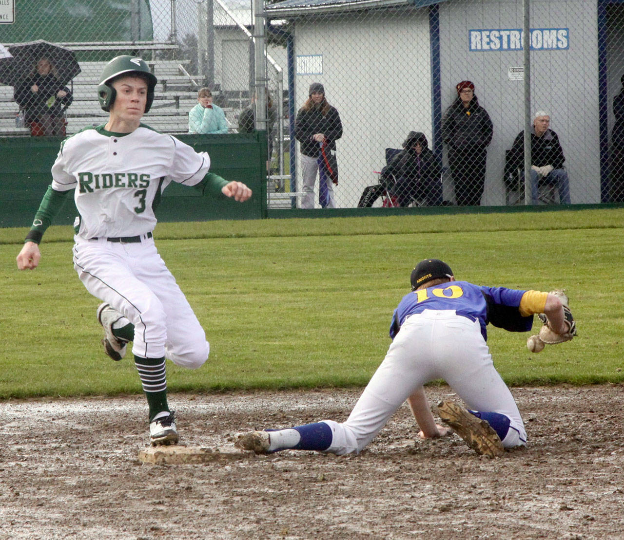 Dave Logan/for Peninsula Daily News                                Port Angeles’ Joel Wood reaches first base safely as the throw to Bremerton first baseman Sawyer Singer was low in the dirt.
