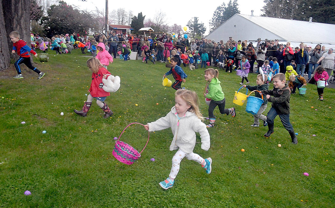 Youngsters race from the starting area to collect prize-filled eggs during Saturday’s 39th annual KONP Easter Egg Hunt at the Clallam County Fairgrounds in Port Angeles. Hundreds of children took part in the event, traditionally the biggest egg hunt on the North Olympic Peninsula. (Keith Thorpe/Peninsula Daily News)