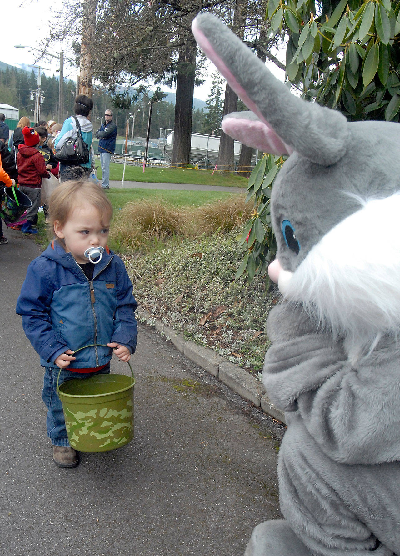 Two-year-old Nason Henning of Port Angeles casts a wary glance at the Easter Bunny, portrayed by Makena Merideth, before the start of the 39th annual KONP Easter egg hunt at the Clallam County Fairgrounds in Port Angeles on Saturday. (Keith Thorpe/Peninsula Daily News)                                Two-year-old Nason Henning of Port Angeles casts a wary glance at the Easter Bunny, portrayed by Makena Merideth, before the start of the 39th annual KONP Easter egg hunt at the Clallam County Fairgrounds in Port Angeles on Saturday. (Keith Thorpe/Peninsula Daily News)
