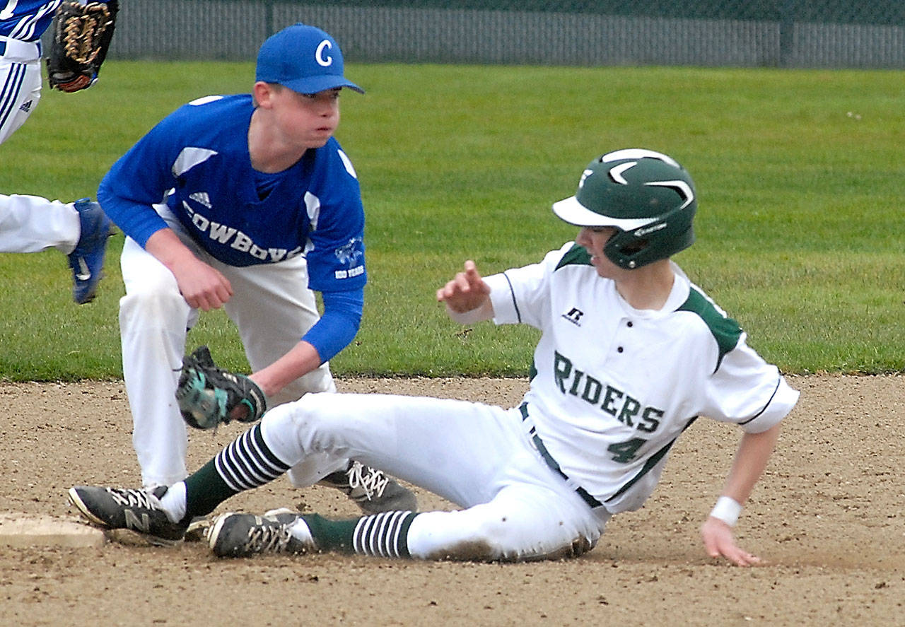 Keith Thorpe/Peninsula Daily News Chimacum shortstop Issac Purser, left, looks at Port Angeles’ Anthony Quinones after tagging him out on a steal attempt in the third inning on Friday at Volunteer Field in Port Angeles.