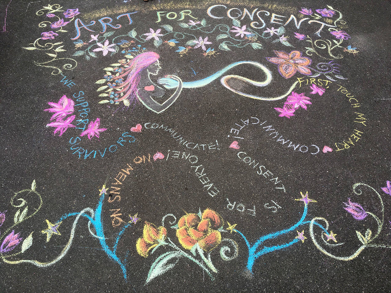 Dove House volunteers kicked off the Art for Consent event with a large chalk mural in the Dove House parking lot earlier this month. (Dove House)