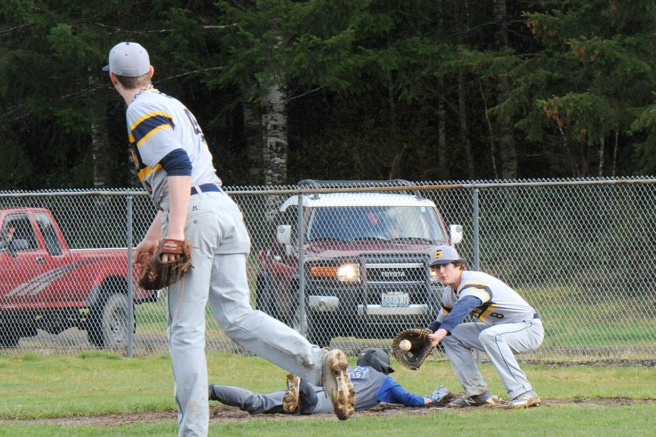 Lonnie Archibald/for Peninsula Daily News Forks&rsquo; Parker Browning throws to Brett Moody covering first in a attempt to pick Elma&rsquo;s Colton French. French was safe on the play. Forks went on to win 10-2.                                Lonnie Archibald/for Peninsula Daily News Forks pitcher Parker Browning throws to Brett Moody covering first in a attempt to pick Elma&rsquo;s Colton French. French was safe but the Eagles were defeated by Forks 10 to 2.