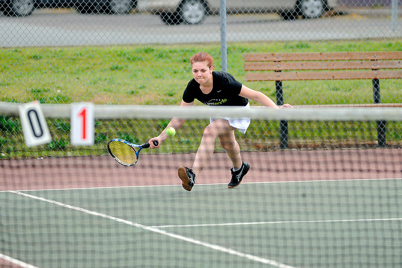 Matthew Nash/ Olympic Peninsula News Group Sequim&rsquo;s Stephanie LaCour scoops up the ball to save a shot against Port Angeles&rsquo; Summer Olsen on Wednesday. LaCour and the Wolves swept the Roughriders 7-0.