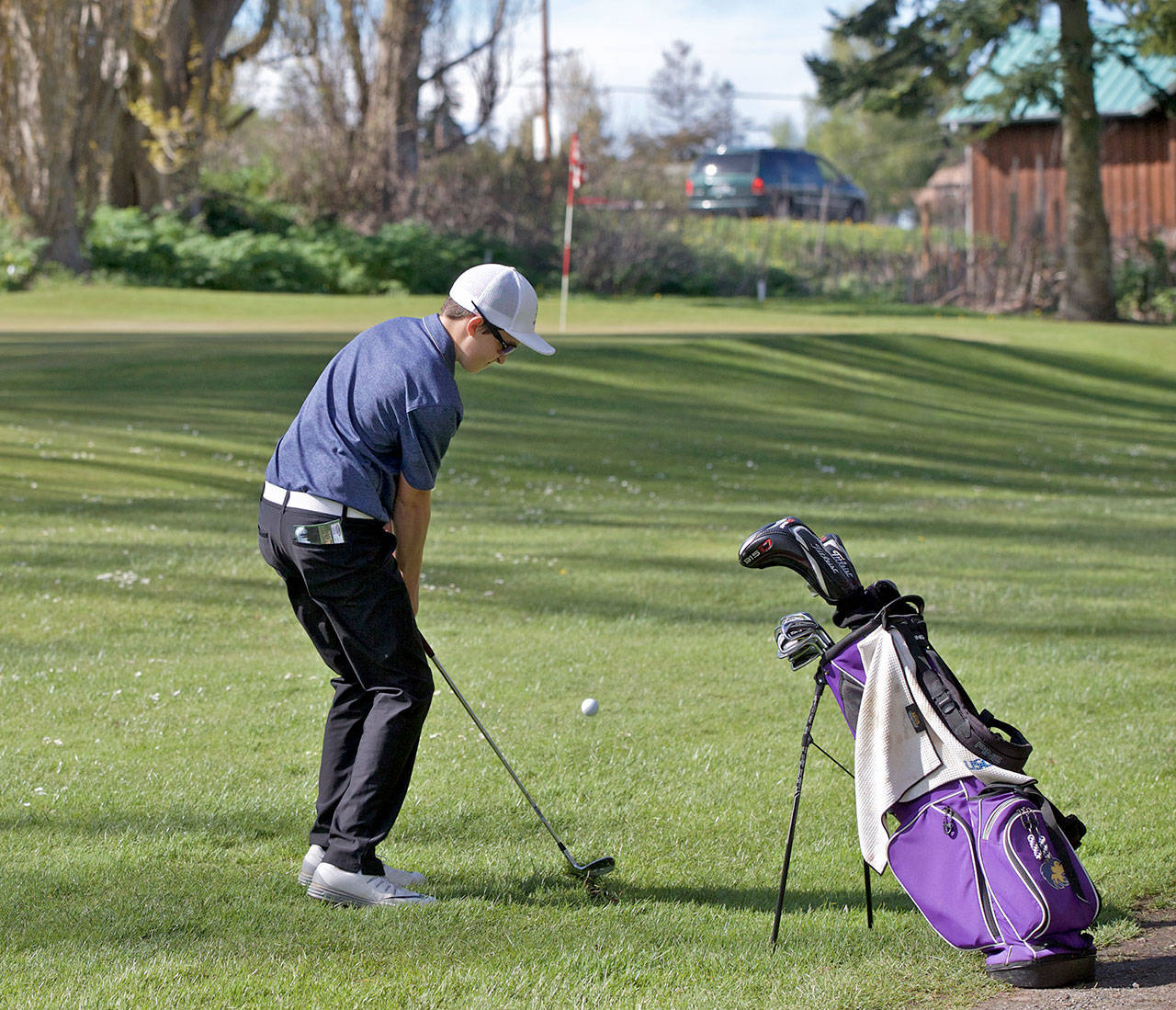 Steve Mullensky/for Peninsula Daily News Sequim’s Paul Jacobsen, chips for the green on the first hole during a match against Port Townsend at Port Townsend Golf Club.