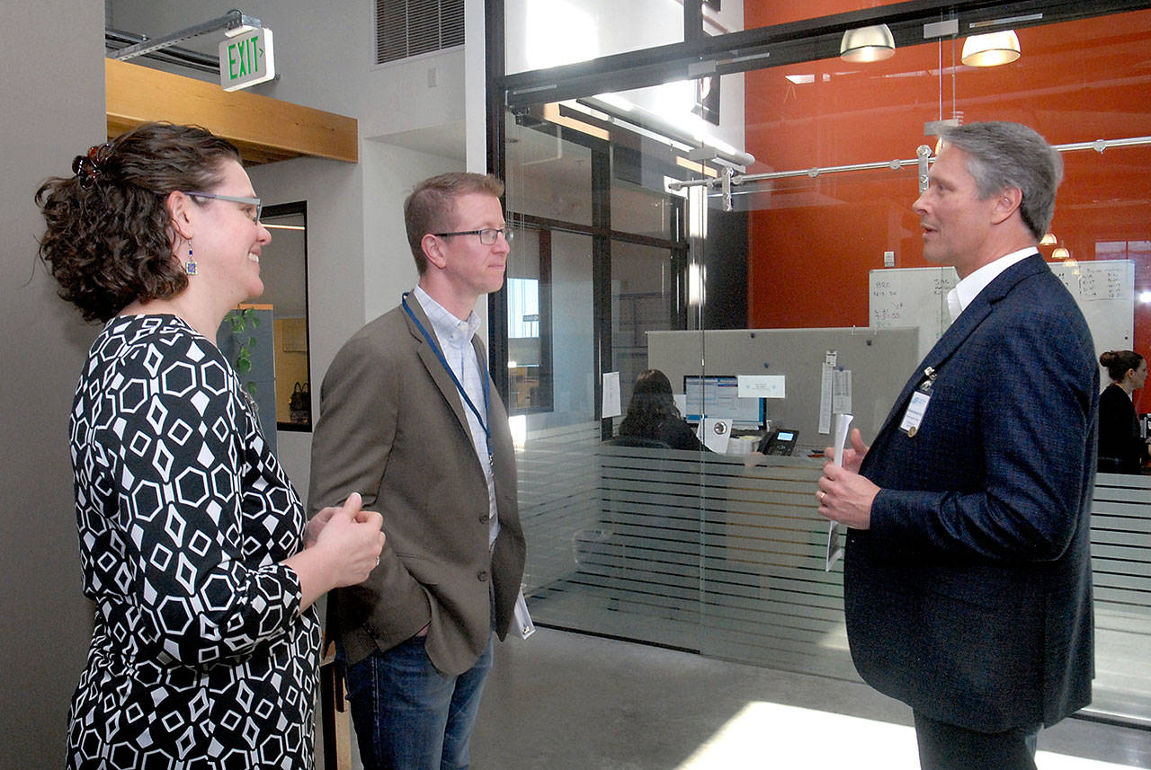 U.S. Rep. Derek Kilmer, center, tours the Port Angeles clinic of the North Olympic Healthcare Network on Friday with Kate Weller, the center’s chief medical officer, and CEO Michael Maxwell. (Keith Thorpe/Peninsula Daily News)