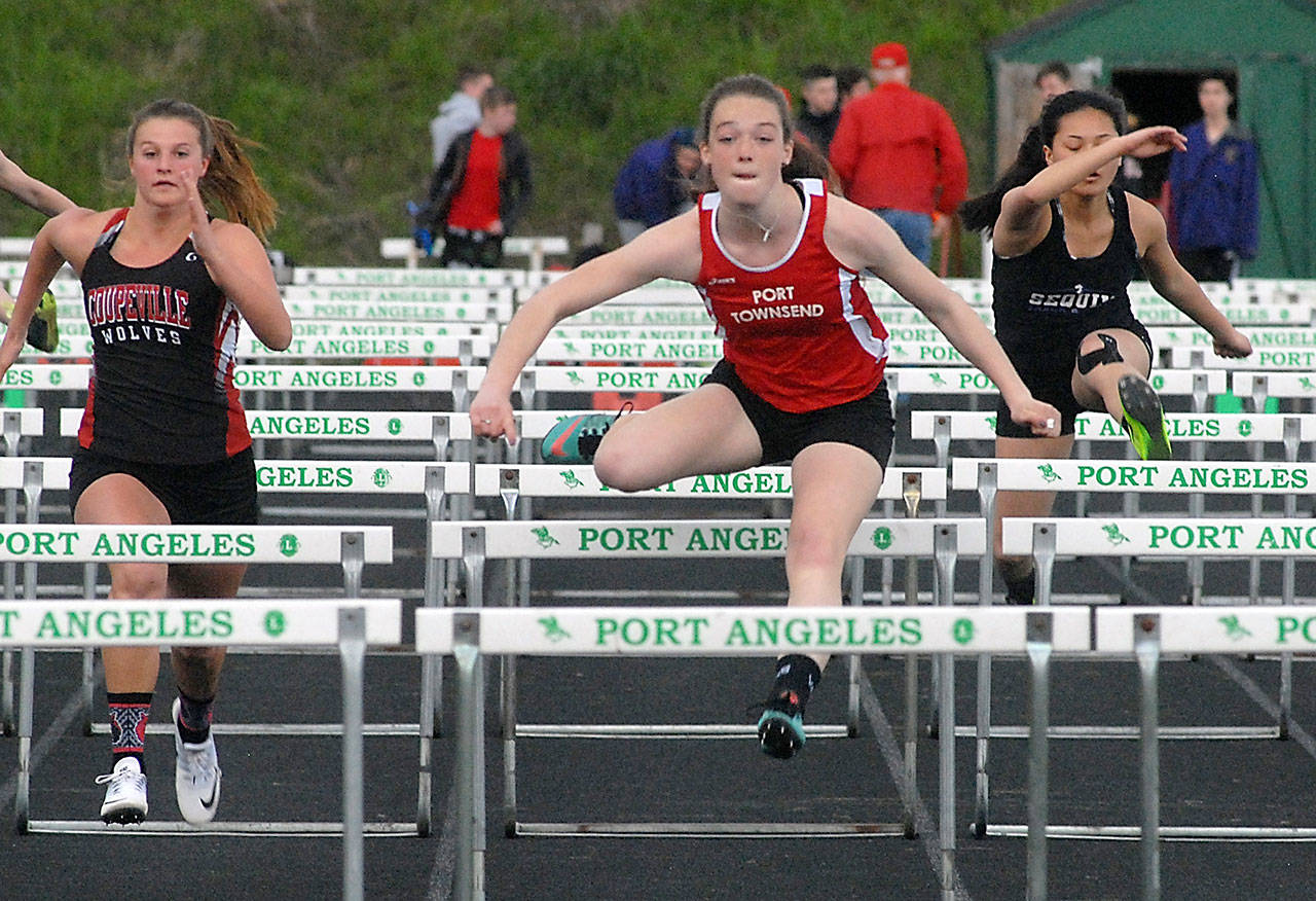 Keith Thorpe/Peninsula Daily News Port Townsend’s Aubry Botkin, center, pulls ahead of competitors Lindey Roberts of Coupville, left, and Shayli Schuman of Sequim, right, to win the girls 100 meter hurdles.