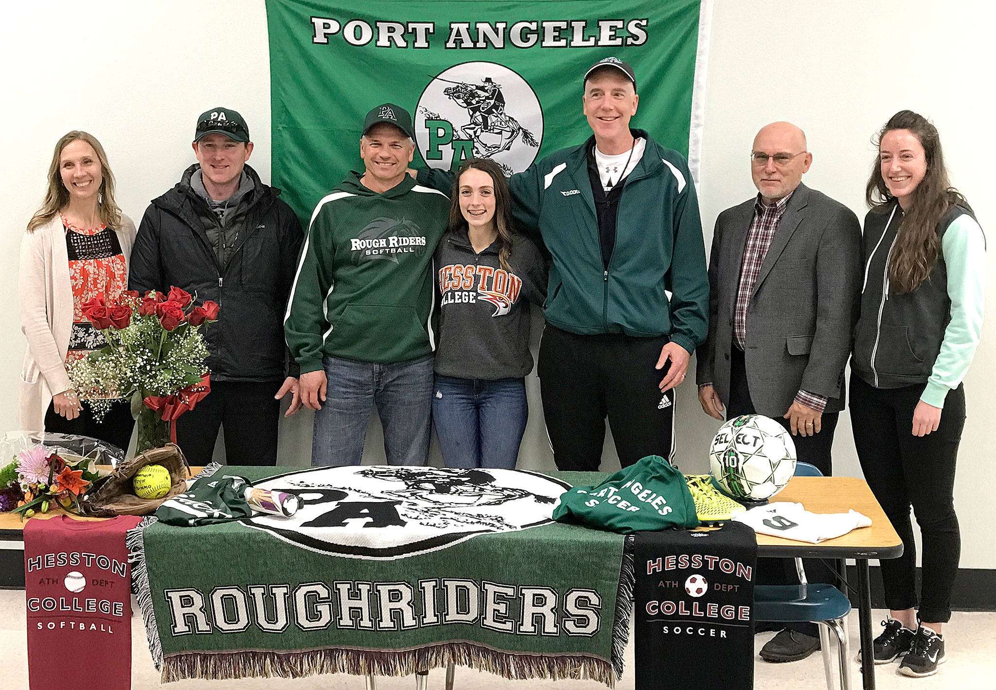 Port Angeles’ Taylar Clark with her coaches at Port Angeles High School after Clark’s signing ceremony for Hesston College, Iowa, on Friday. From left are Jeri Boe, soccer; Rob Edwards, softball; Randy Steinman, Roughriders softball head coach; Clark; Scott Moseley, soccer; Chuck Perrizo, softball; and Kathryn Moseley, soccer.