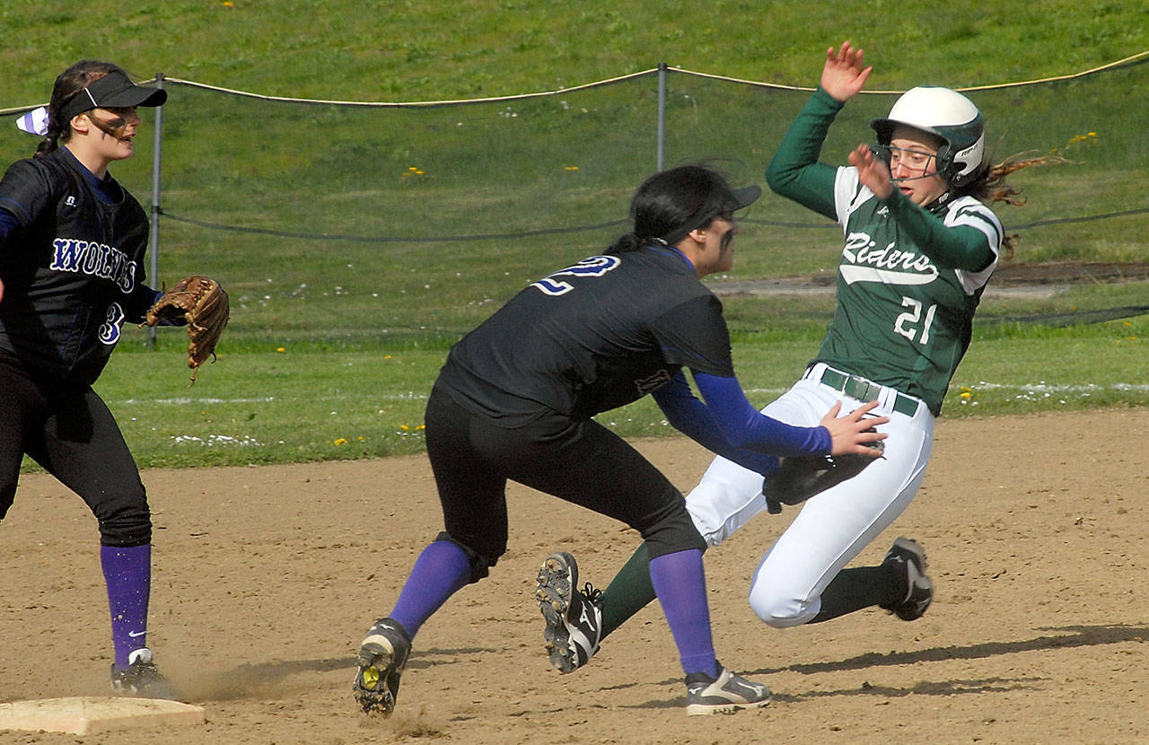 Keith Thorpe/Peninsula Daily News                                Port Angeles’ Erin Edwards, right, slides into second ahead of the throw to Sequim’s Bobbi Sparks, center, as teammate Lydia Stidham backs up the play in the second inning on Wednesday at the Dry Creek Athletic Complex in Port Angeles.