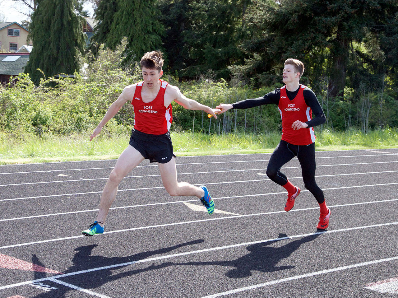 Steve Mullensky/for Peninsula Daily News                                Port Townsend’s Seren Dances takes the baton from teammate Berkley Hill and runs the anchor leg of the boys 4X200 relay race during a meet at Blue Heron Middle School on Friday. The team, consisting of Dances, Hill, Gerry Coker and Kyle Blankenship, went on to set an new school record in the race with at time of 1:33.49.