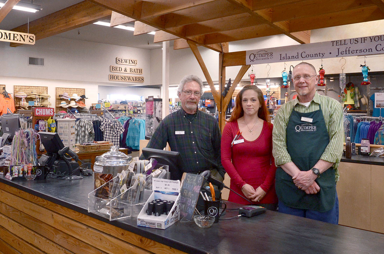 Quimper Mercantile employees Ken Hulick, Sereta Rondeau and Sheldon Spencer, from left, prepare for a busy Sunday, which will be the first day of a community giving program where a percentage of sales will go to local schools. (Cydney McFarland/Peninsula Daily News)