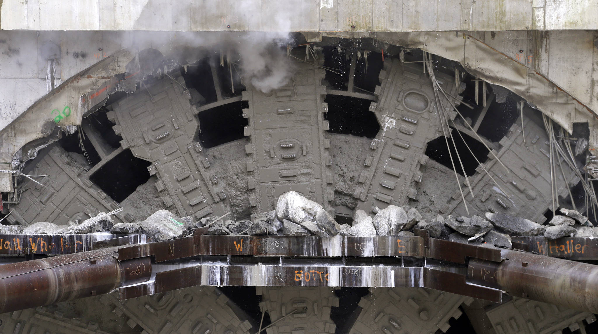 Debris sits atop bracing that had been holding a 5-foot concrete wall as the cutter heads of a massive tunneling machine are fully visible as it completes boring for the state Highway 99 route under Seattle. (Elaine Thompson/The Associated Press)