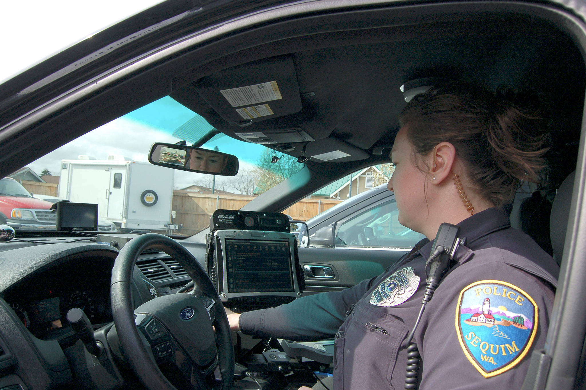 Sequim Police Officer Stephanie Benes readies her 2016 Ford Interceptor for duty on April 11, at the Sequim Civic Center. City staff plans to buy three newer models this year bringing the Sequim Police Department’s total to 10 Interceptors. Sequim Gazette photo by Matthew Nash