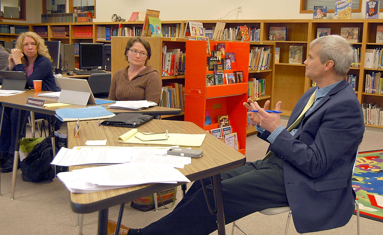 Crescent School Board members Susan Hopper, left, and Board President Trish Haggerty, center, listened to a presentation Thursday by schools Superintendent Dave Bingham. (Paul Gottlieb/Peninsula Daily News)