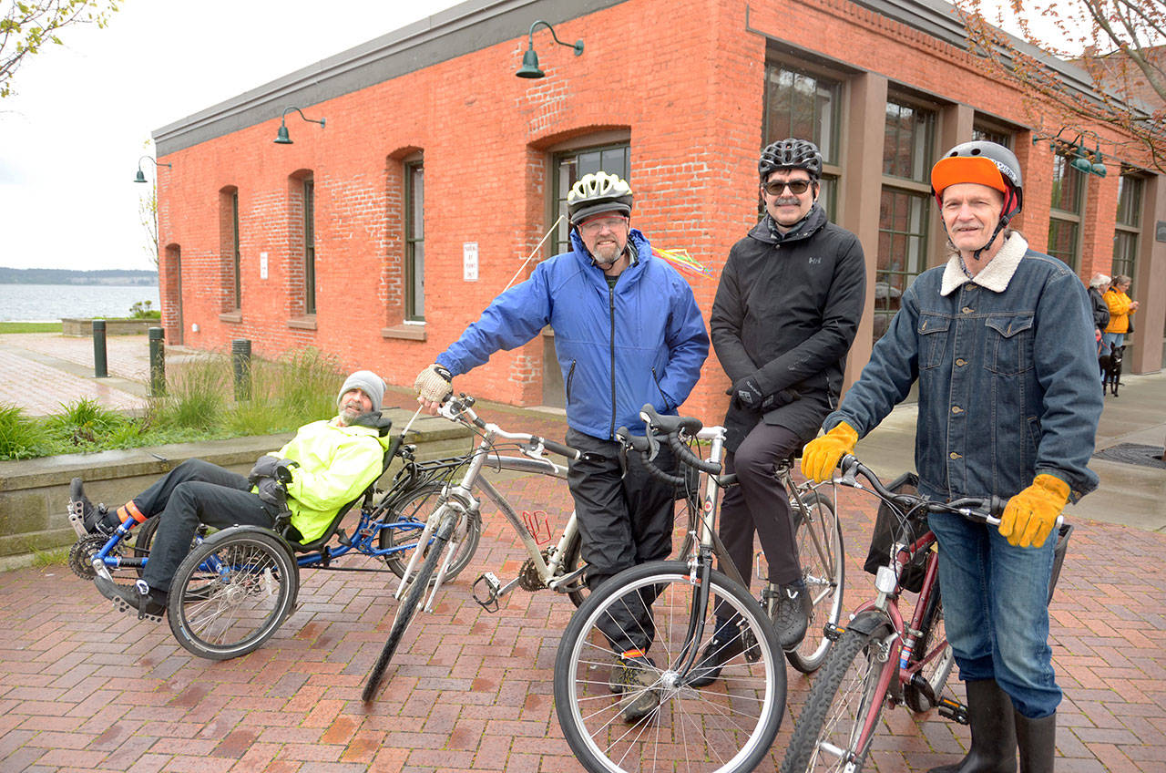 From left, rider Jack McCreary, ride leader Scott Walker, League of American Bicyclists board member Steve Durrant, and rider Sidney Collins braved the rain and celebrated National Bike Month with a ride around Port Townsend. (Cydney McFarland/Peninsula Daily News)