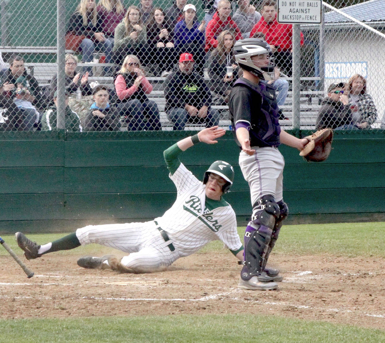 Luke Angevine slides safely into home as the second run of the game for PA as the NK catcher Carson Bower stands waiting for the ball as if to say - give me the ball.