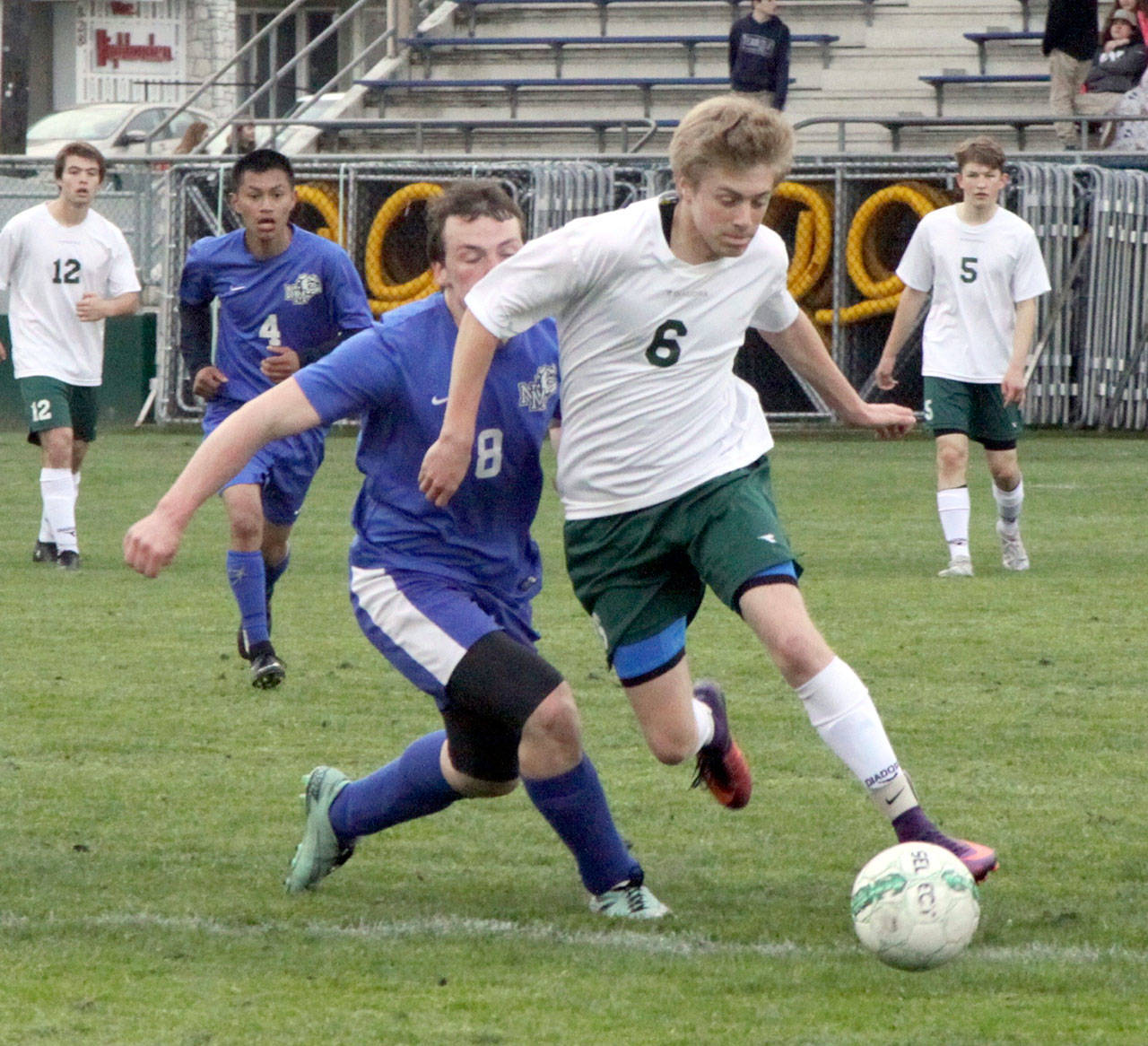By Dave Logan/for Peninsula Daily News Port Angeles’ Ben Schneider (6) fends off North Mason’s Richard Miller in the Roughriders’ 6-0 win Monday night at Civic Field. The win keeps the Riders in good position for a playoff slot.