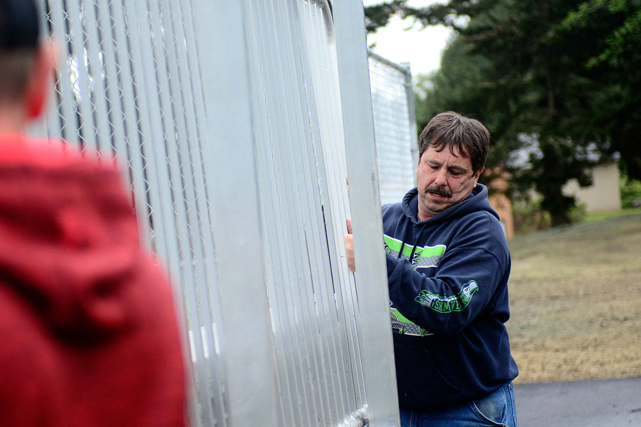 Warren Stevens, facilities and maintenance director for the Lower Elwha Klallam Tribe, helps build bleachers at the tribe’s new athletic facility, the Billy Whiteshoes Memorial Park. (Jesse Major/Peninsula Daily News)