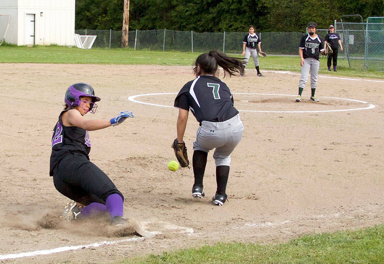 Steve Mullensky/for Peninsula Daily News                                 Quilcene’s Gina Brown slides into third ahead of the throw to Muckelshoot’s Miranda Jackson, during the first game of a doubleheader played in Quilcene on Wednesday.