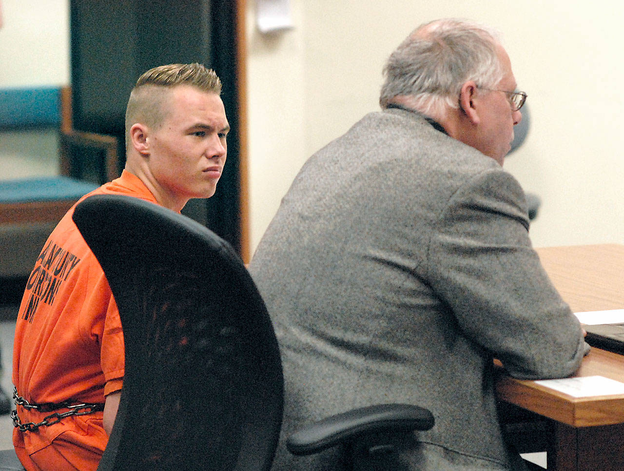 Benjamin Bonner looks at defense attorney Harry Gasnick during Bonner’s first appearance in Clallam County Superior Court on Friday on charges of second-degree murder, animal cruelty and theft of a motor vehicle. (Keith Thorpe/Peninsula Daily News)
