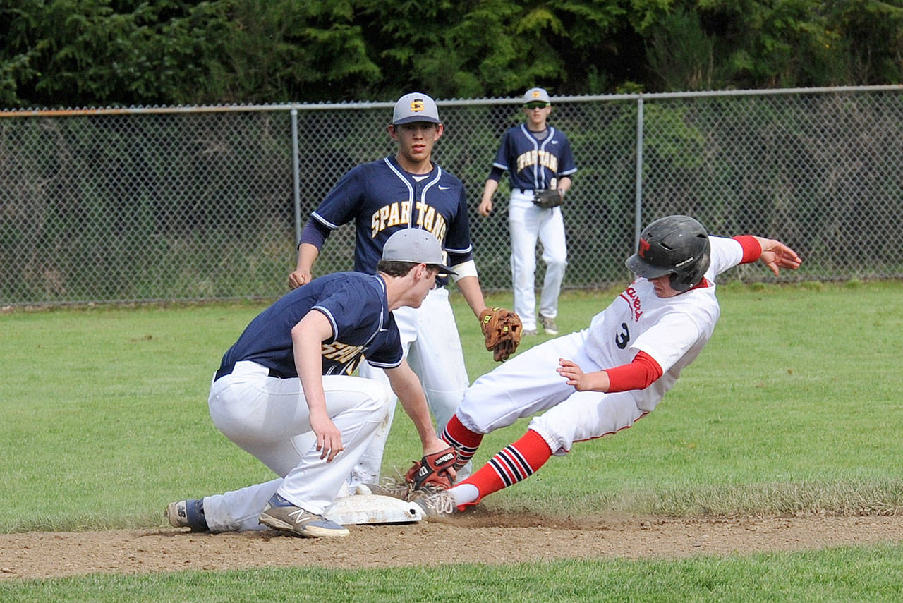 Lonnie Archibald/for Peninsula Daily News Forks shortstop Brett Moody tags Tenino’s Rob Wall (3) out at second on an attempted steal. Looking on for Forks are Josh Salazar (18) and Rob Anderson (9). Tenino defeated Forks 12 to 2.