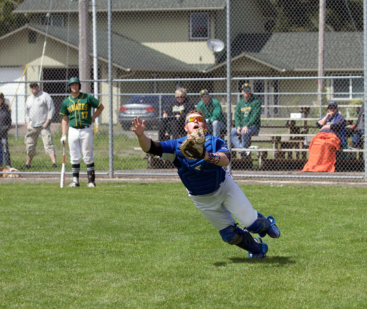 Steve Mullensky/for Peninsula Daily News Chimacum catcher, Lane Dotson, dives for a pop-up during a play-off game against Vashon on Saturday in Chimacum.