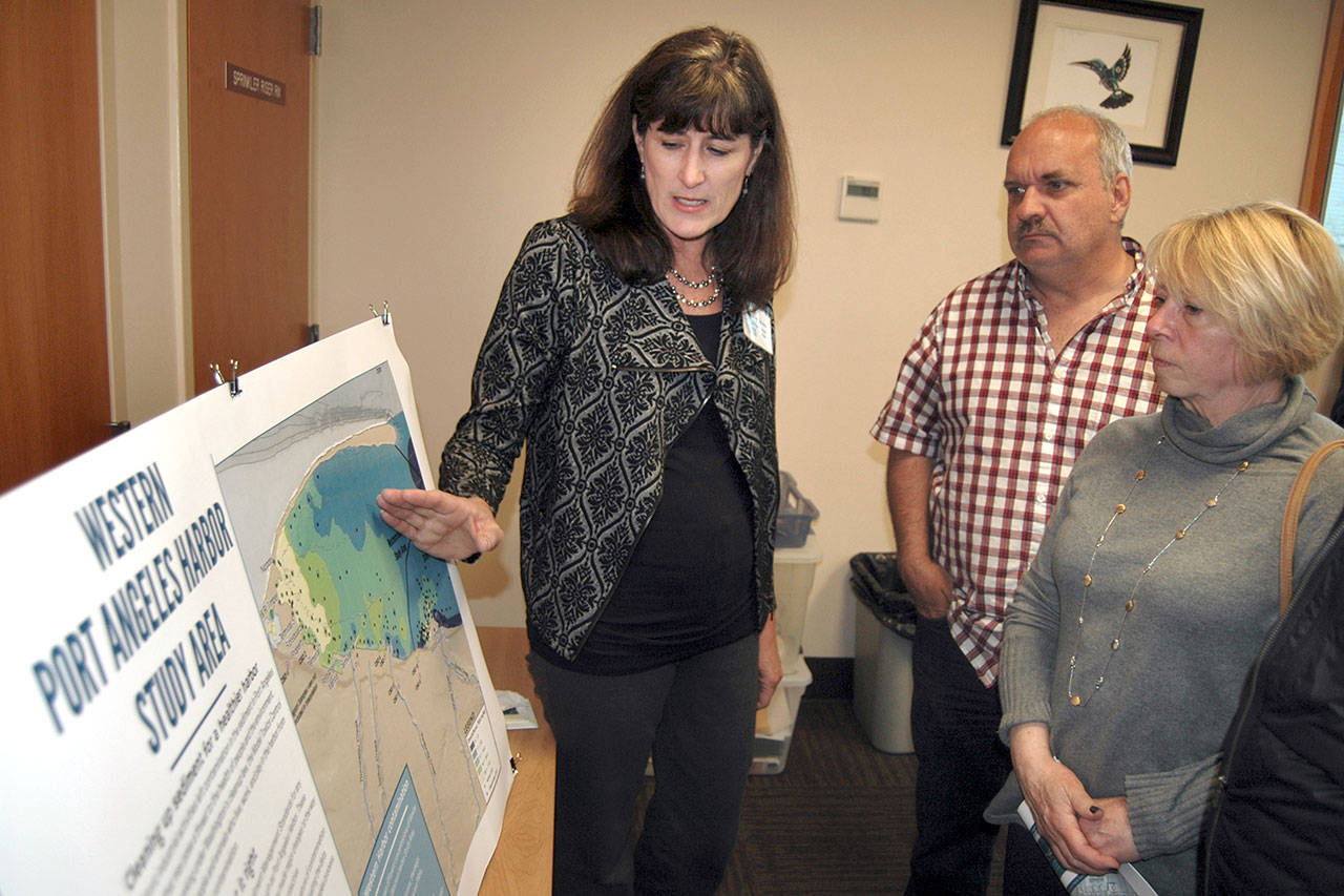 State Department of Ecology project manager Connie Groven describes the agency’s cleanup activities at an open house Tuesday to Port of Port Angeles Commissioners Steve Burke and Connie Beauvais. (Paul Gottlieb/Peninsula Daily News)
