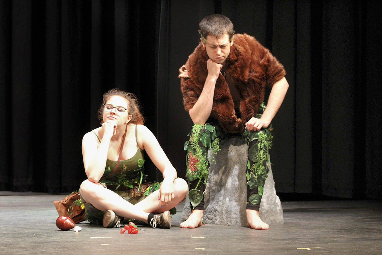 From left, Robin, played by Lily Robertson, and Oberon, played by Zachary Parrill, contemplate their scheme regarding the purple flower, which, when placed on sleeping eyes, causes the victim to fall madly in love with the first being they see upon waking.