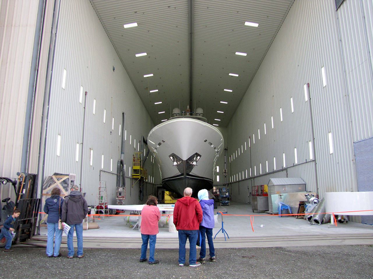 A tour group gazes up at a yacht under repair in the massive Westport Yachts repair bay, which was opened for visitor viewing during the Port of Port Angeles’ inaugural Waterfront Days last year. (Peninsula Daily News)