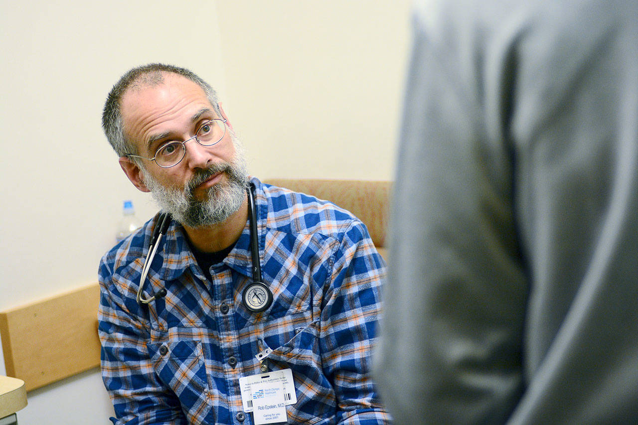 Dr. Robert Epstein talks to a patient who is in North Olympic Healthcare Network’s medication-assisted treatment program Monday. NOHN recently was approved for $250,000 in funding to expand its program from about 120 patients to about 300 patients. (Jesse Major/Peninsula Daily News)