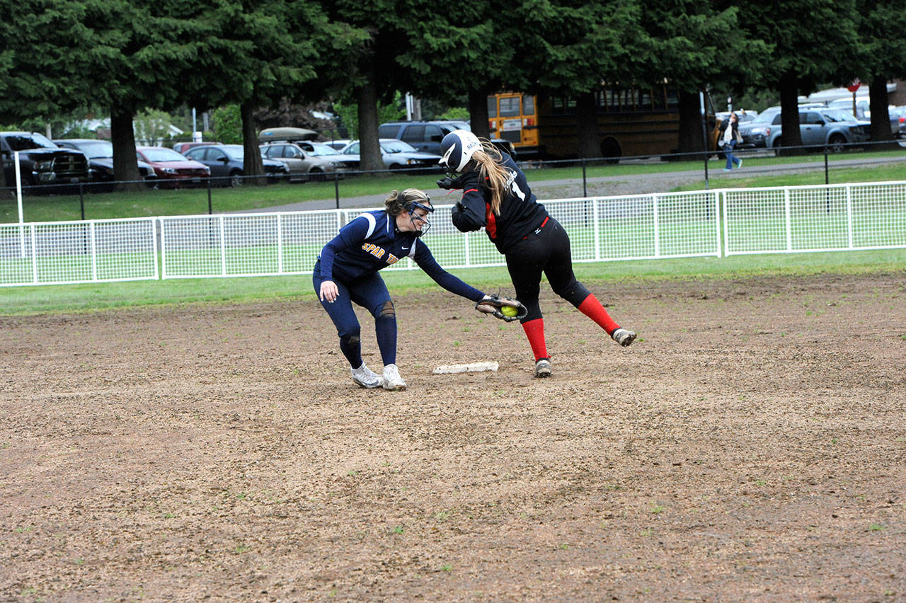 Lonnie Archibald/for Peninsula Daily News                                Forks shortstop Julia Lausche tags White Salmon’s Amanda Waldron out at second in an attempted steal on a throw from Forks catcher Rian Peters.