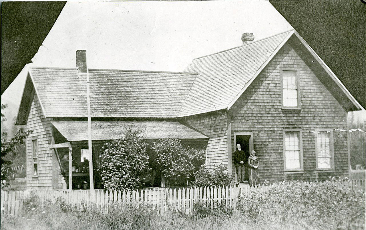 The home of Capt. Samuel and Mary Clements is shown in Brinnon with the Clements standing on the front steps. (Jefferson County Historical Society)