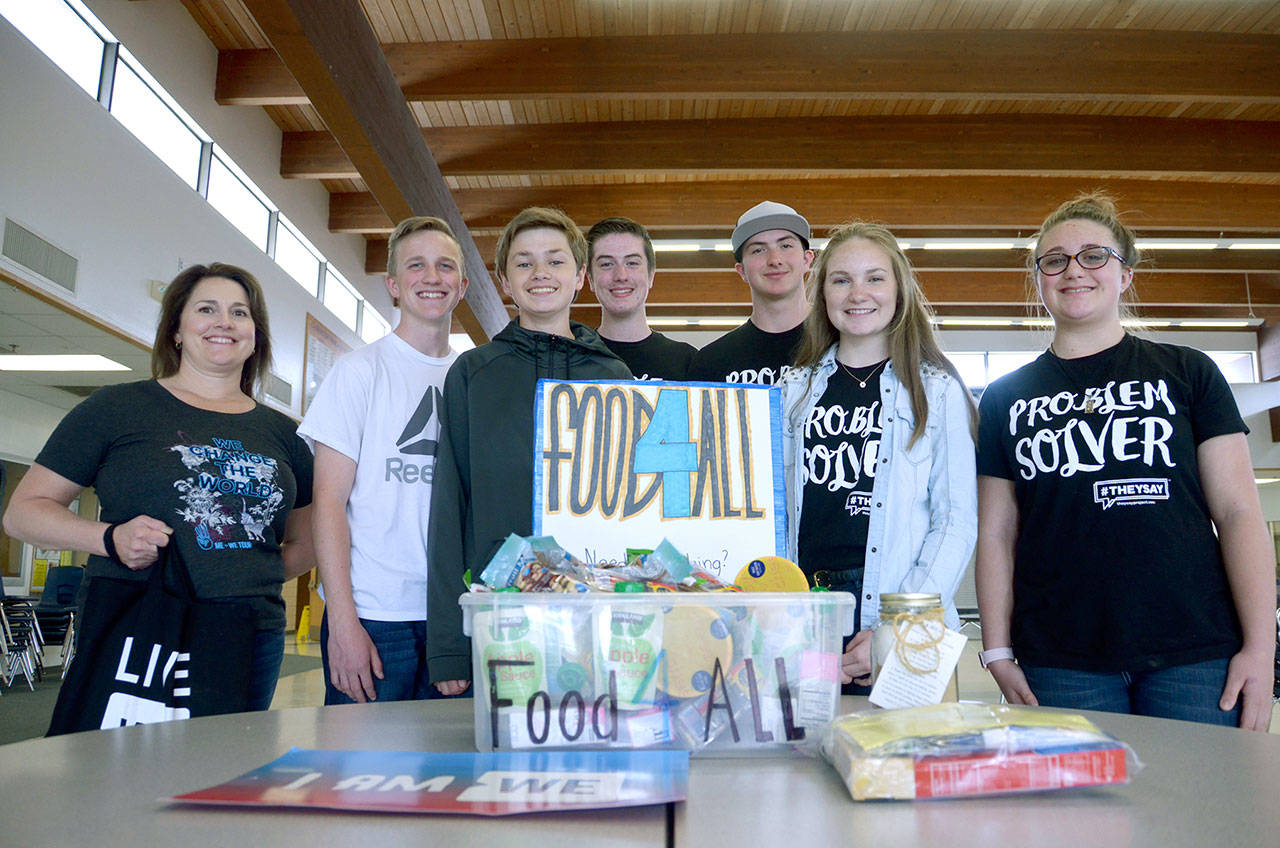 Chimacum High School students Cora Willis, Lacey Bishop, Kyle Tenny, Mason Lawson, Zachery Engle, Seth Richey and We Act Club adviser Piper Diehl, from left, were honored for their Food4All donation box. (Cydney McFarland/Peninsula Daily News)