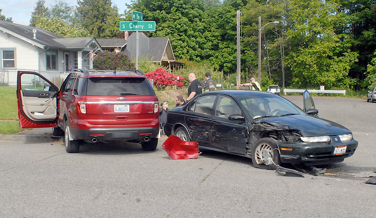 Two vehicles partially block the intersection at Fifth and Cherry streets in Port Angeles after colliding on Wednesday morning. (Keith Thorpe/Peninsula Daily News)