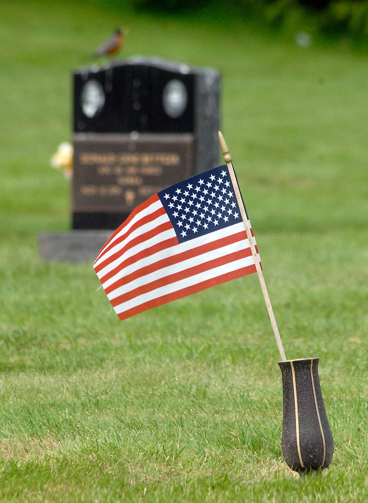 An American flag adorns a grave at Mount Angeles Memorial Park in Port Angeles. (Keith Thorpe/Peninsula Daily News)