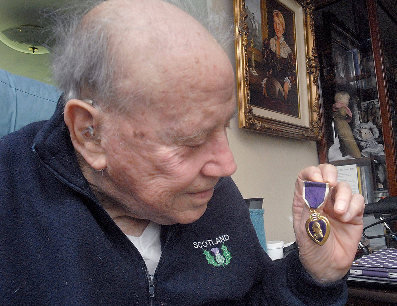 Marion “Skip” Yandell displays one of two Purple Hearts he received during his service with the U.S. Marine Corps. (Keith Thorpe/Peninsula Daily News)