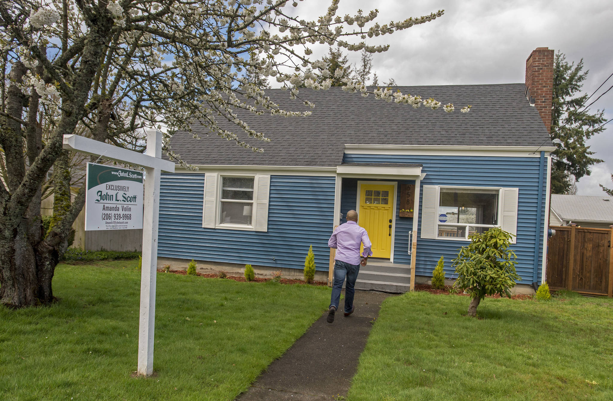 Real estate broker James Pitts III walks up to the fully remodeled childhood home of serial murderer Ted Bundy in Tacoma. (Peter Haley/The News Tribune via AP)