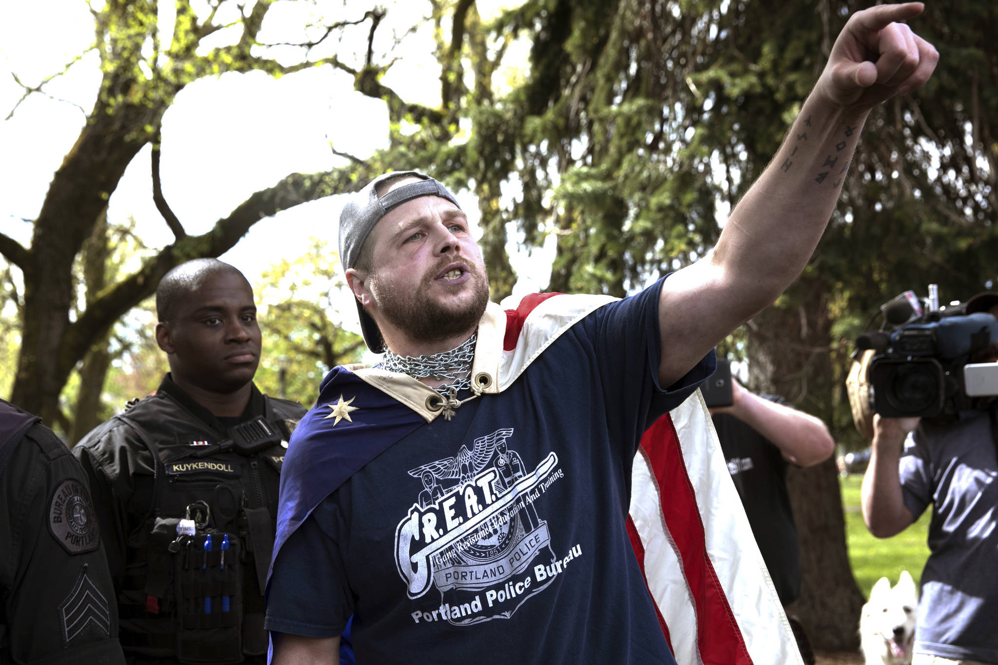 In an April 29 photo provided by John Rudoff, Jeremy Joseph Christian, right, is seen during a Patriot Prayer organized by a pro-Trump group in Portland, Ore. (John Rudoff via AP)