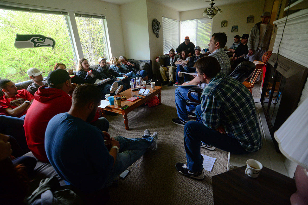 Oxford House residents in Port Angeles during their monthly chapter meeting April 23. The program offers recovering drug addicts housing, structure and support from others in recovery. (Jesse Major/Peninsula Daily News)
