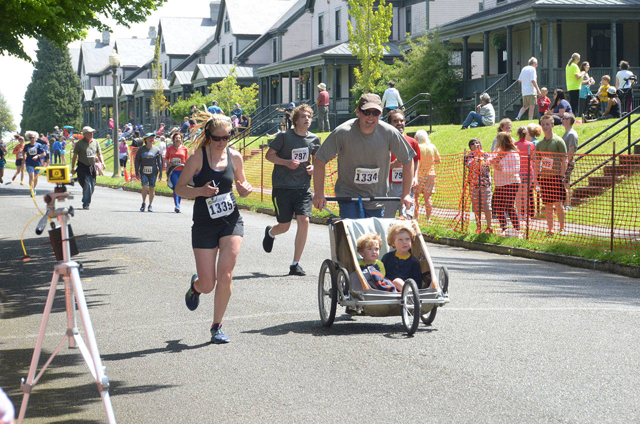 From left, Lea Falkagua, 33, Sean Parsons, 16, Derek Falkenhagen, 36, and Lee Parsons, 53, finish up at the Rhody Run on Sunday, the culmination of almost a week of Rhododendron Festival events in Port Townsend. (Cydney McFarland/Peninsula Daily News)