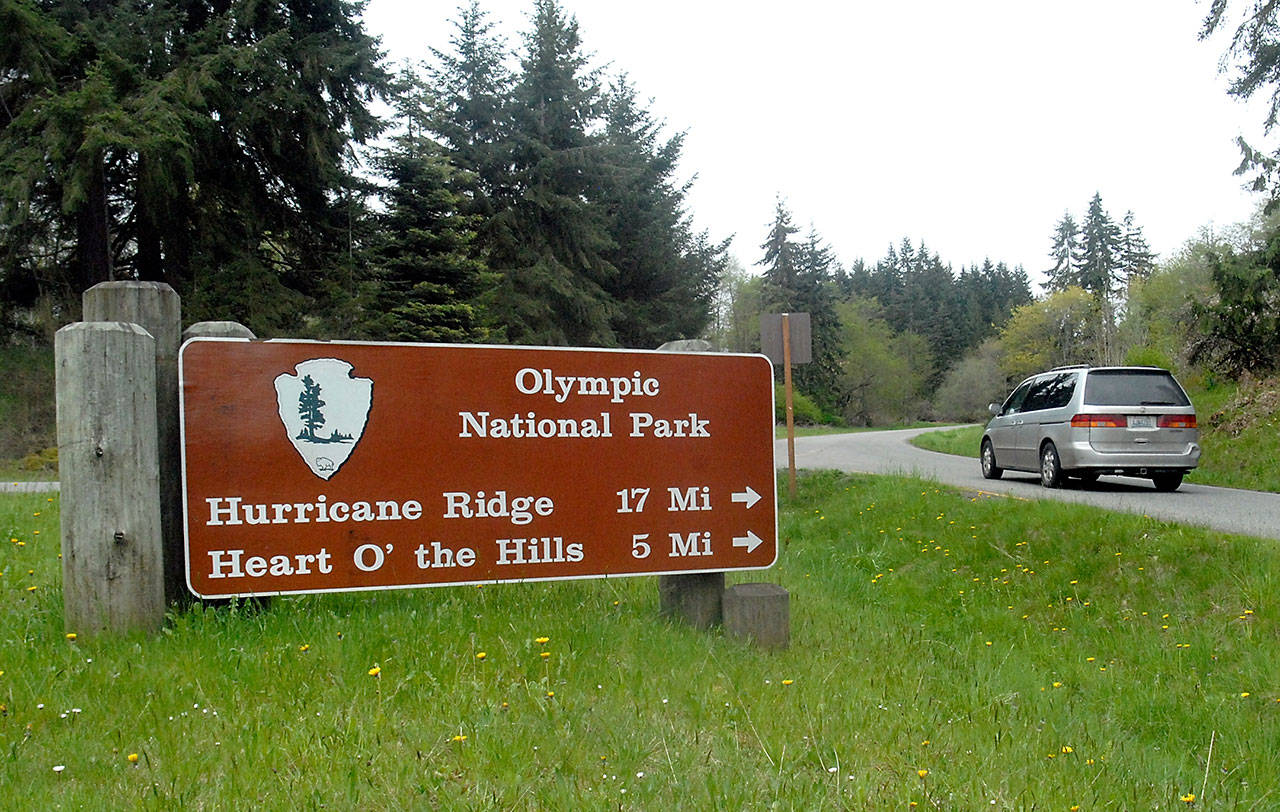 A vehicle makes the turn onto Hurricane Ridge Road towards Heart o’ the Hills and Lake Dawn this spring in Port Angeles. (Keith Thorpe/Peninsula Daily News)